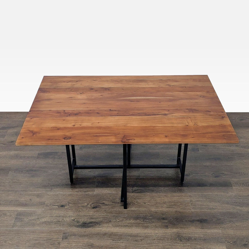 Crate & Barrel dining table featuring Acacia wood top, metal base, and extendable design for 4-6 people.