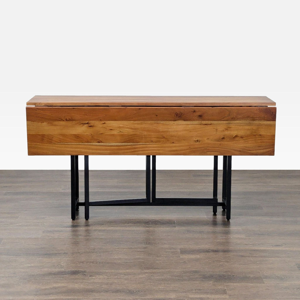Rectangular Acacia wood dining table with metal legs, seats 4-6 with leaves, by Crate & Barrel.