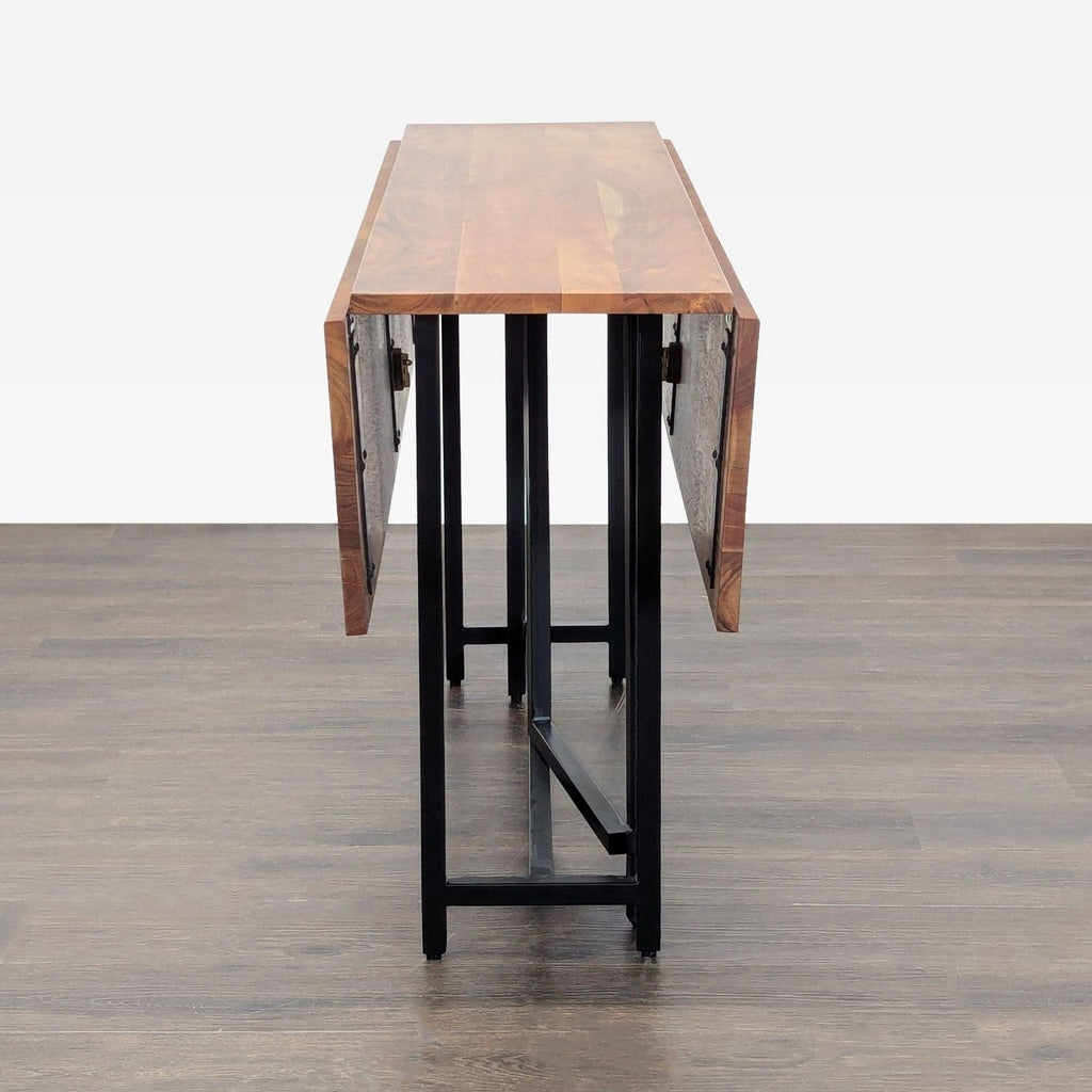 Modern Acacia wood dining table with metal accents, expandable to seat 4-6, from Crate & Barrel.