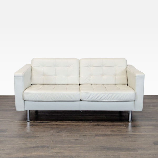 1. White Ikea loveseat with tufted cushions and stainless steel legs, shown from the front on a wood floor.