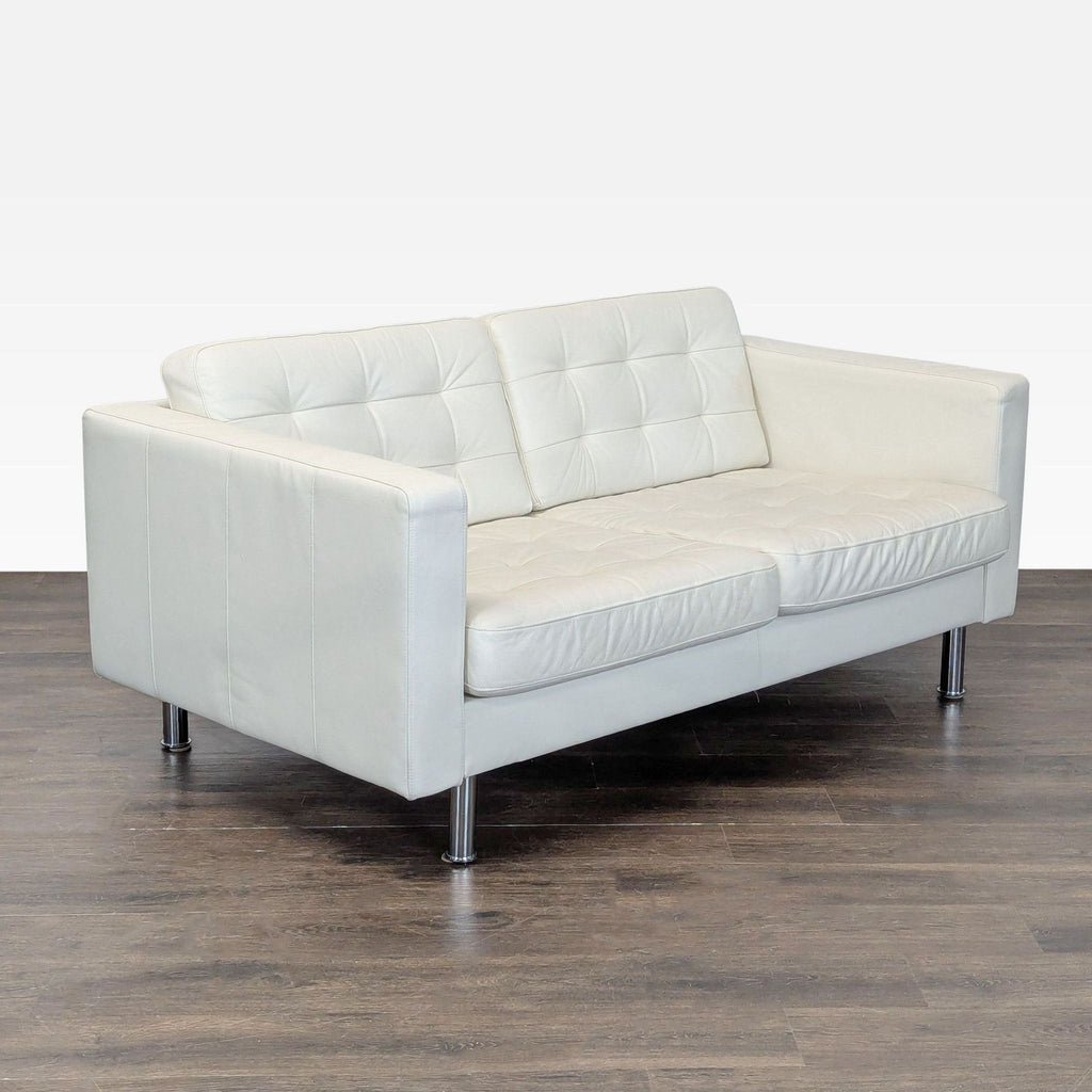 2. Modern white leather Ikea loveseat, compact design with comfy seats and metal legs, displayed at an angle.