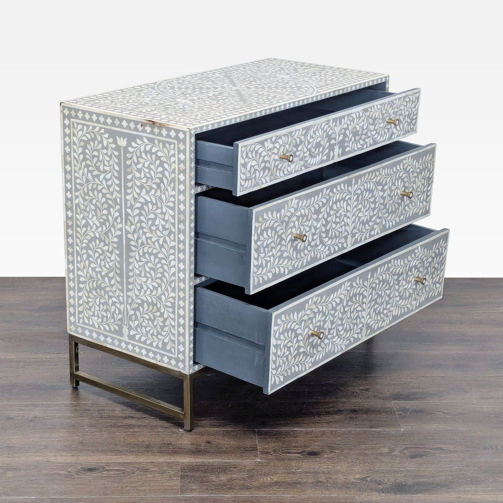Elegant dresser featuring intricate floral bone inlay, soft gray finish, and spacious storage drawers.