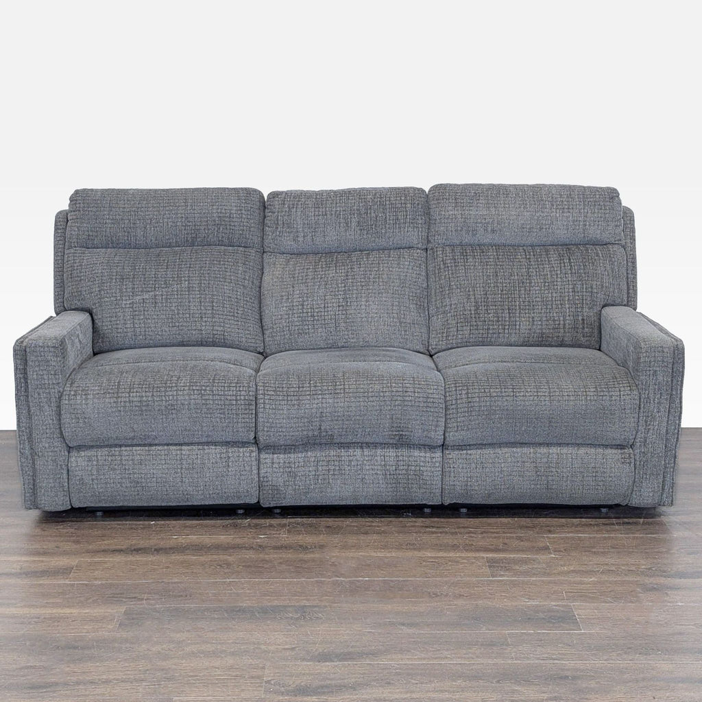 1. Front view of a Living Spaces 3-seat gray sofa with plush cushions and modern design on wood flooring.