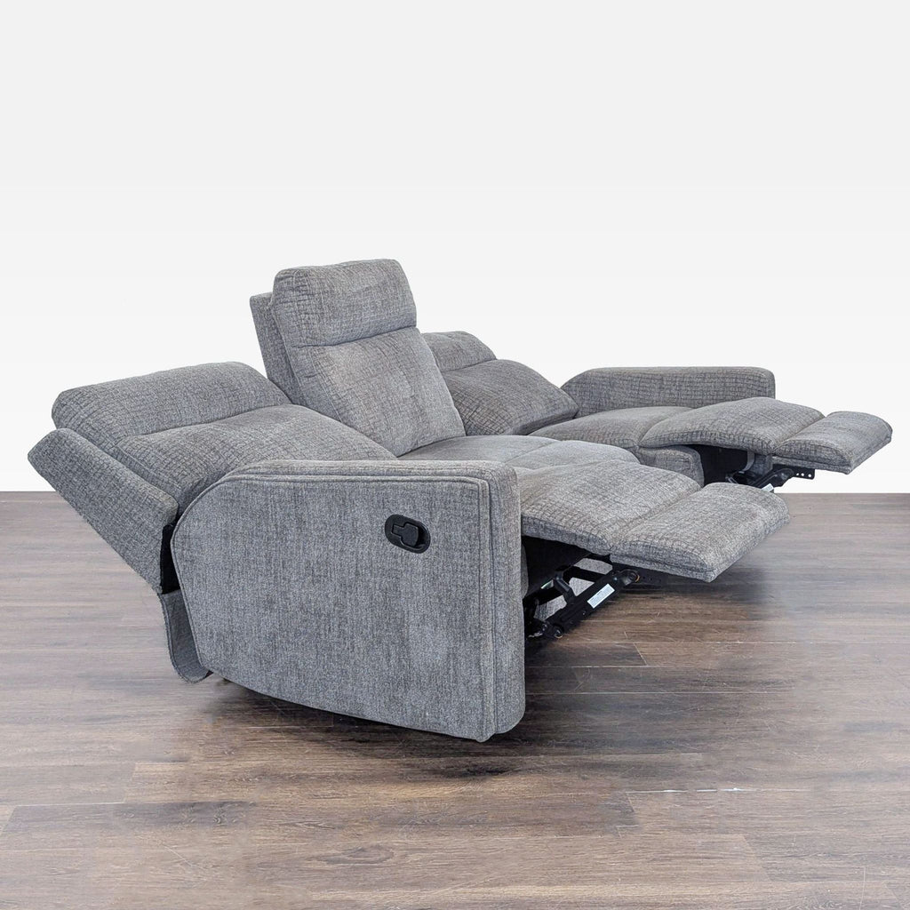 2. Side view showing both manual recliners extended on the Living Spaces 3-seat gray fabric sofa.