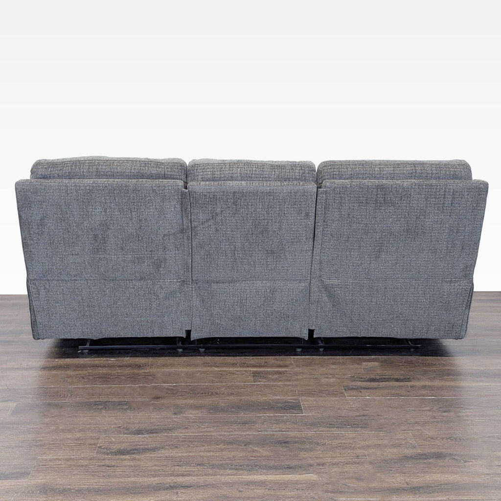 3. Rear view of the Living Spaces 3-seat sofa, displaying its sturdy gray upholstered back.