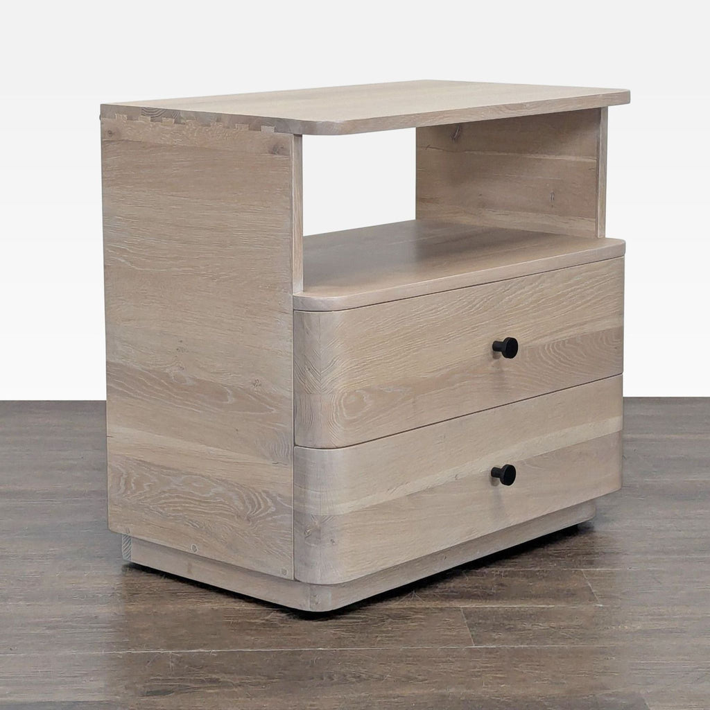 3. Side angle of a modern light wood end table with rounded corners, two drawers, and an open upper shelf.
