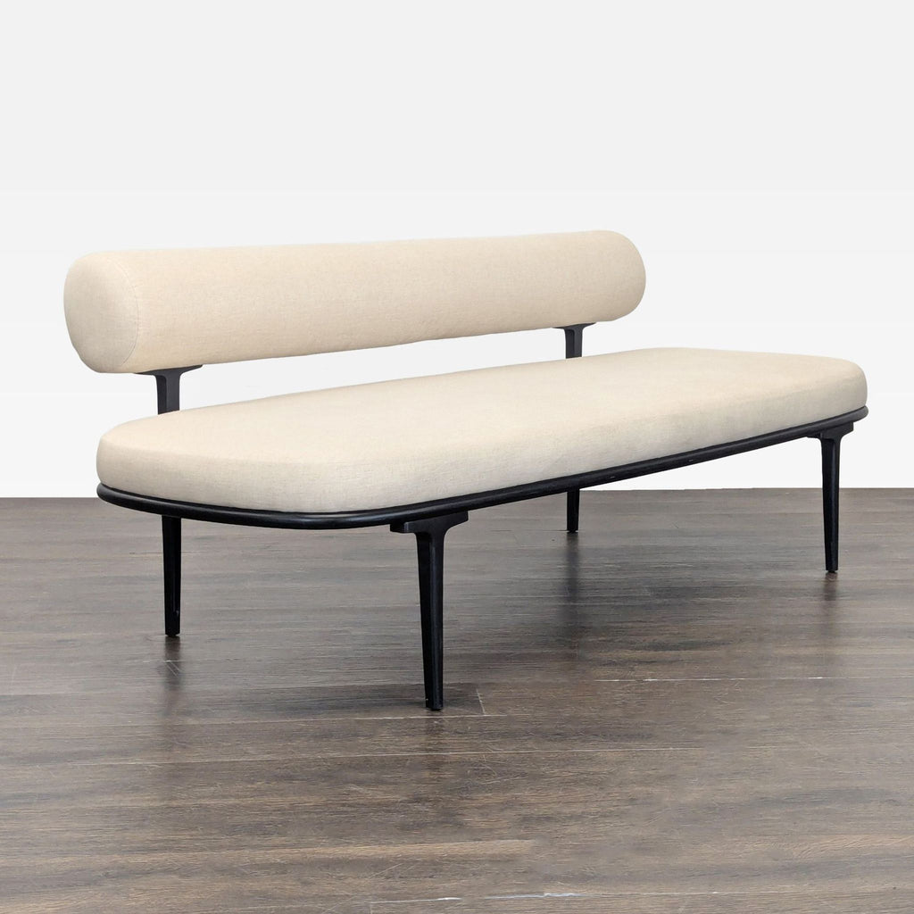 Modern CB2 sofa in cream fabric, featuring a sleek design and sturdy black metal legs for style and comfort.
