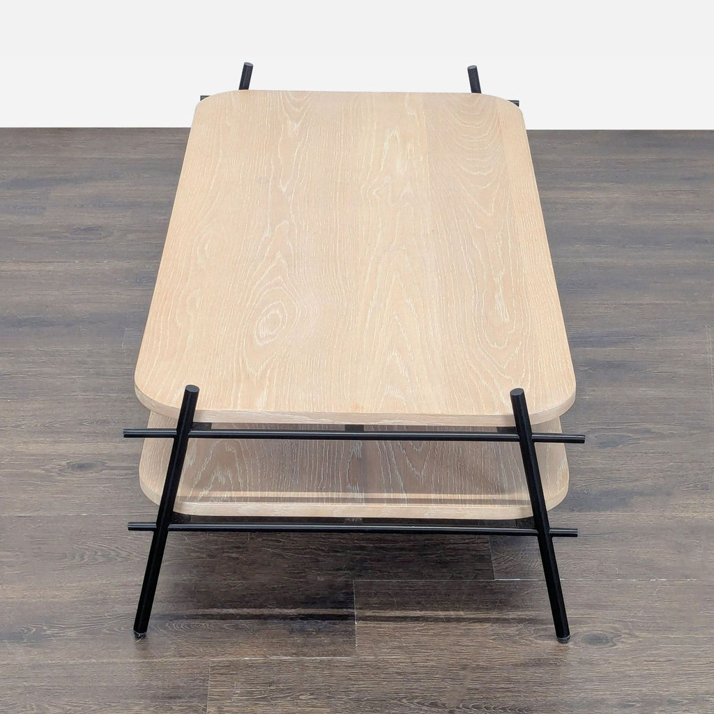 3. Overhead view of a coffee table, featuring light wood surfaces and black metal frame with rounded corners.