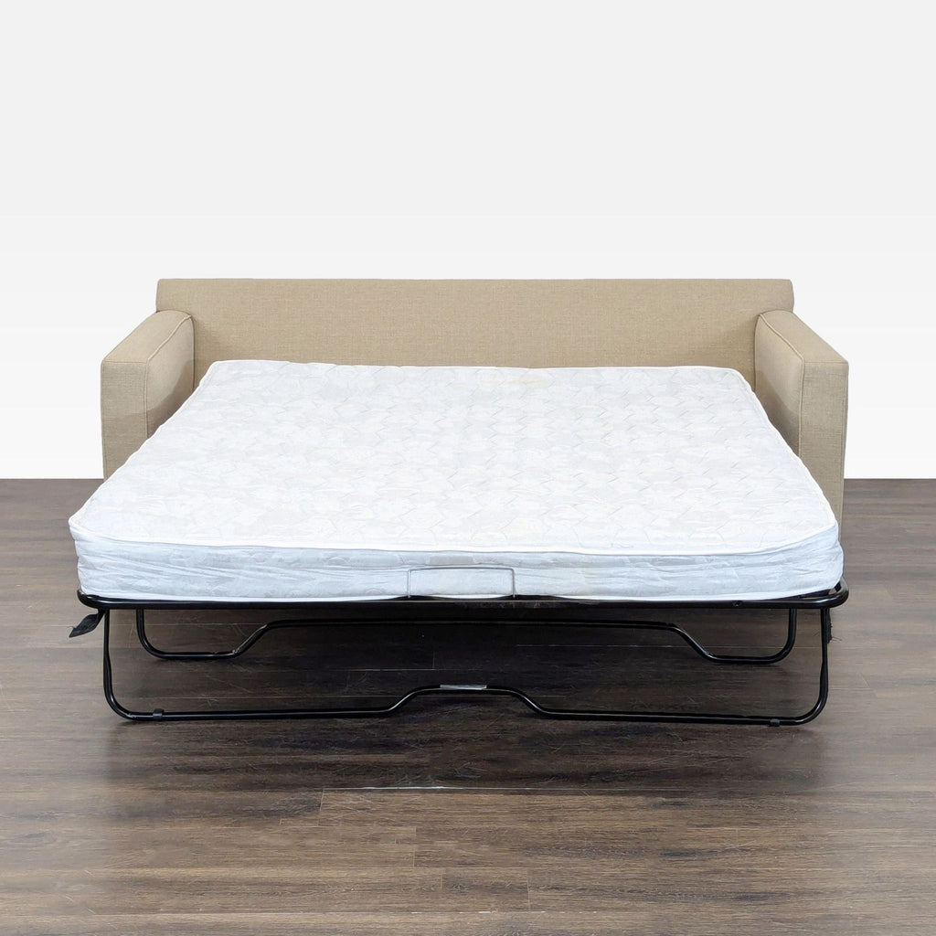 Neutral beige Crate & Barrel sleeper sofa, featuring simple lines and cozy seating, ideal for versatile living spaces.  