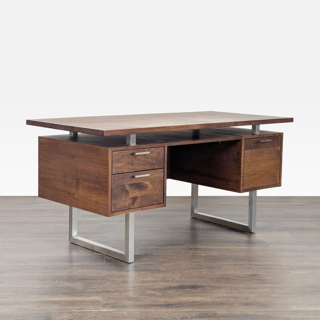 Angled view of a modern Crate & Barrel desk, showing walnut finish, metal legs, and functional storage drawers.