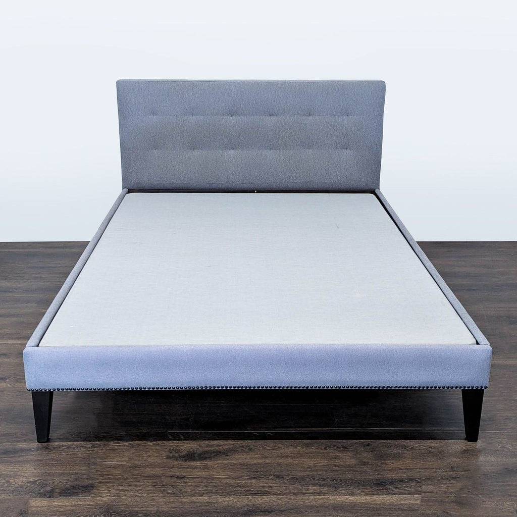 West Elm Queen bed frame with grey tufted headboard and wooden legs, modern and supportive.