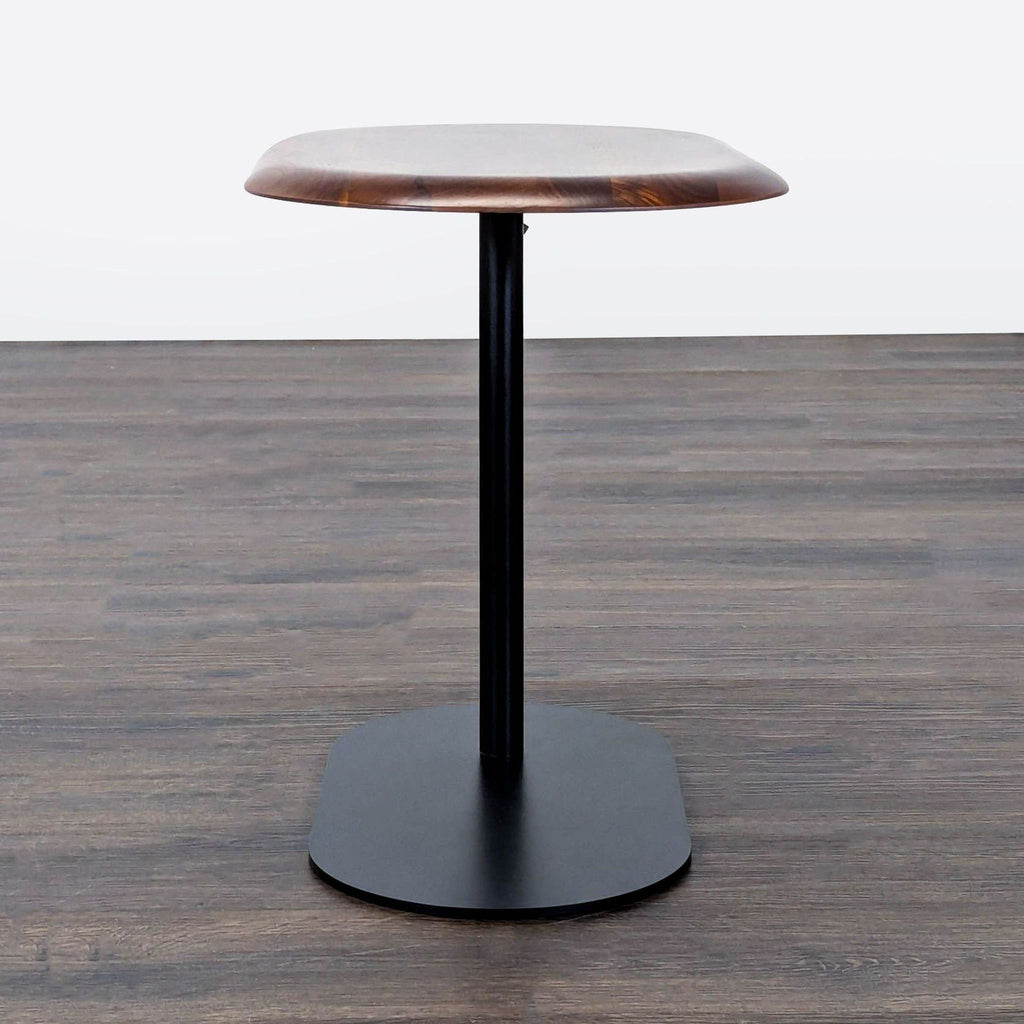 Modern console table from Article, featuring an adjustable wood surface and powder-coated steel legs.