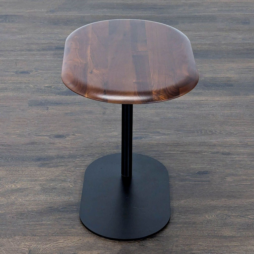 Article brand side table with a height-adjustable wood top and sturdy black metal base.