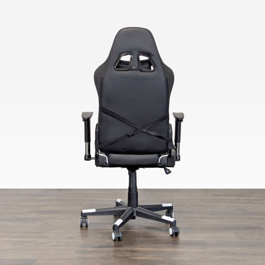 Modern black and white office chair by GTRacing, featuring sturdy base and supportive pillows, ready for use.