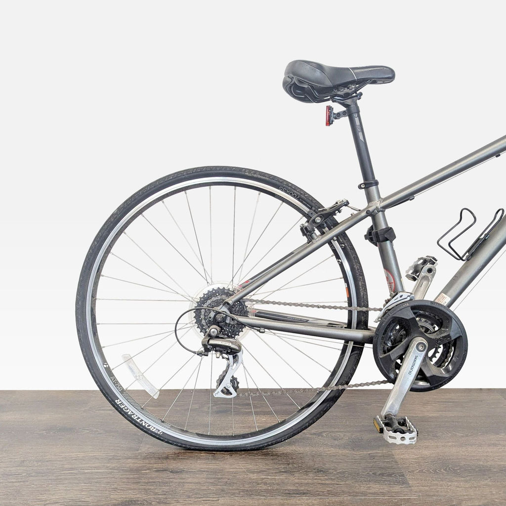 Lightweight Trek hybrid bicycle featuring reliable rim brakes and comfortable saddle, suitable for casual riders.