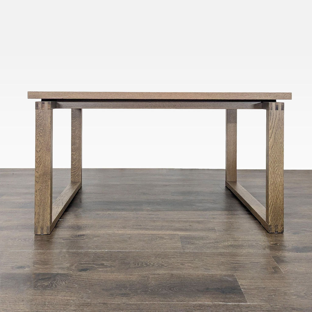 1. Minimalist rectangular wooden dining table with clean lines and sturdy open-frame legs on a wood floor.