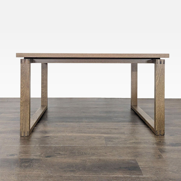 1. Minimalist rectangular wooden dining table with clean lines and sturdy open-frame legs on a wood floor.
