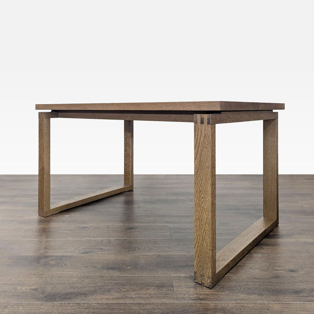 3. Side angle of a modern wooden dining table with rectangular legs, highlighting its simple, geometric design.
