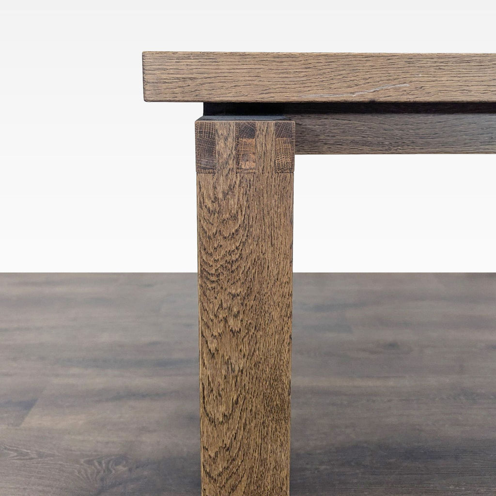 2. Close-up of a dining table leg, showing detailed wood grain and joinery against a wooden floor.