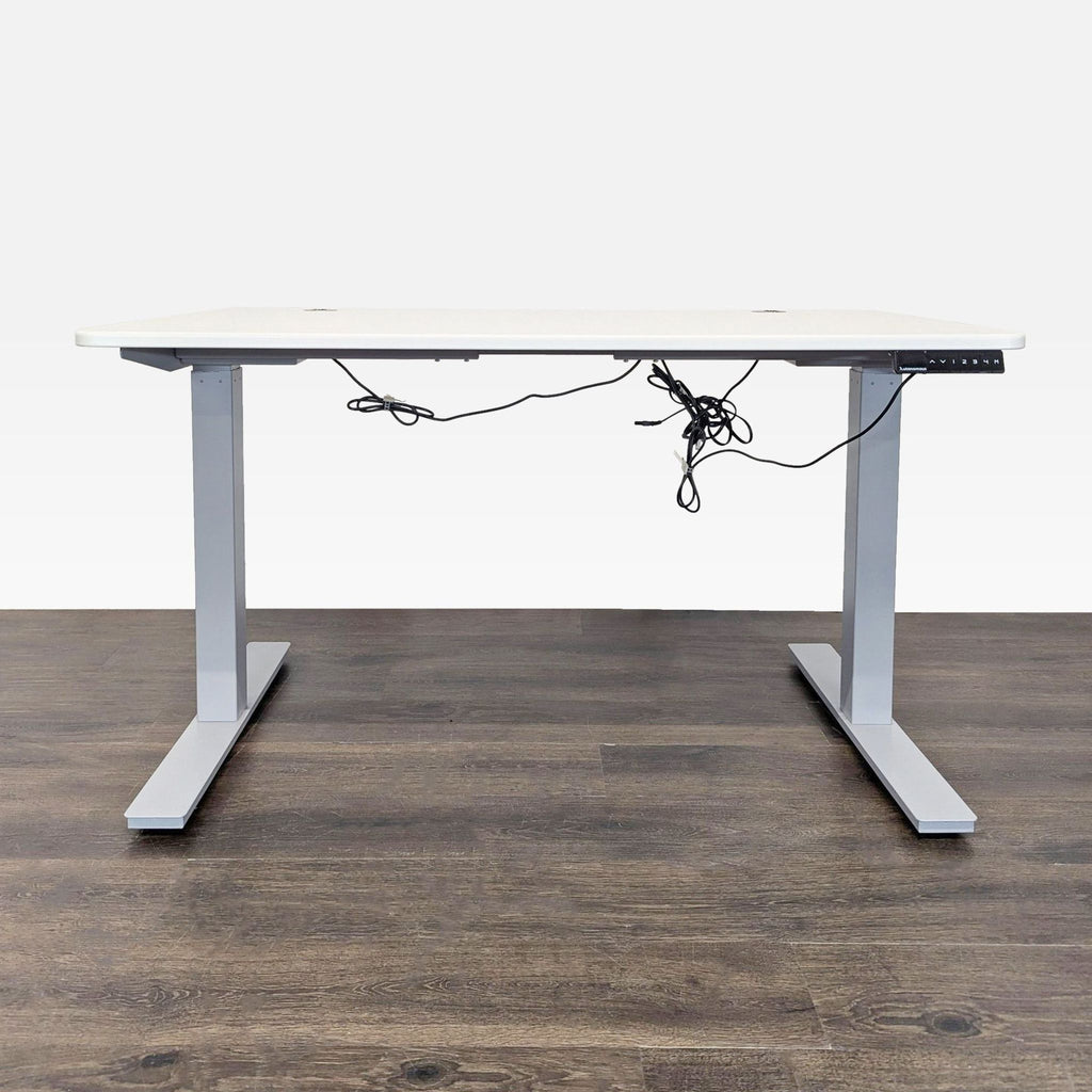Autonomous white standing desk with electric height adjustment and programmable control panel for comfort and productivity.