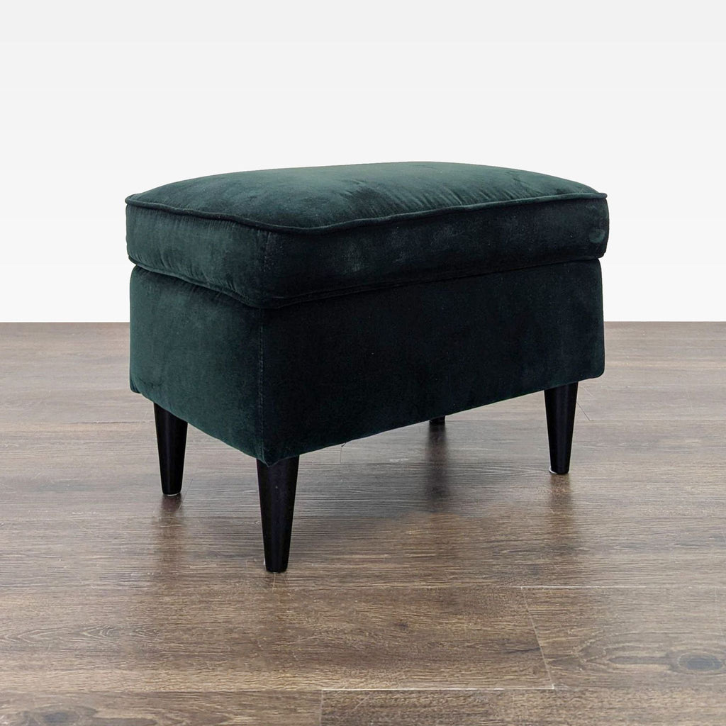 Ikea velvet lounge chair with button details and footstool, offering comfort and support in deep green.