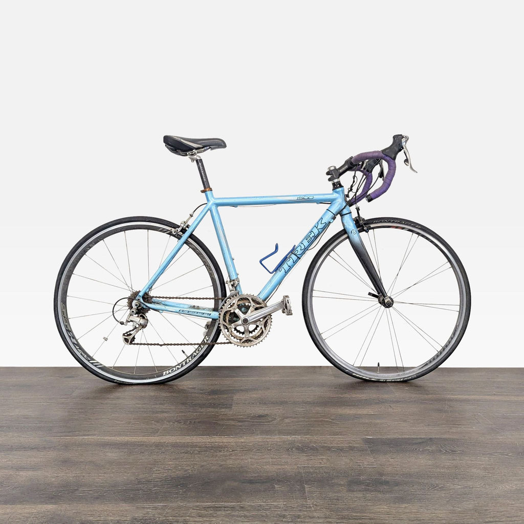 1. Light blue Trek 1500 road bike with drop handlebars and Bontrager wheels, showing signs of use.