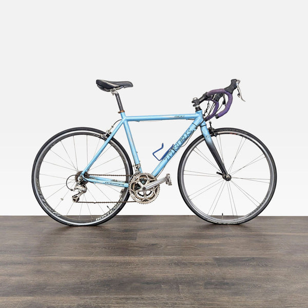 1. Light blue Trek 1500 road bike with drop handlebars and Bontrager wheels, showing signs of use.