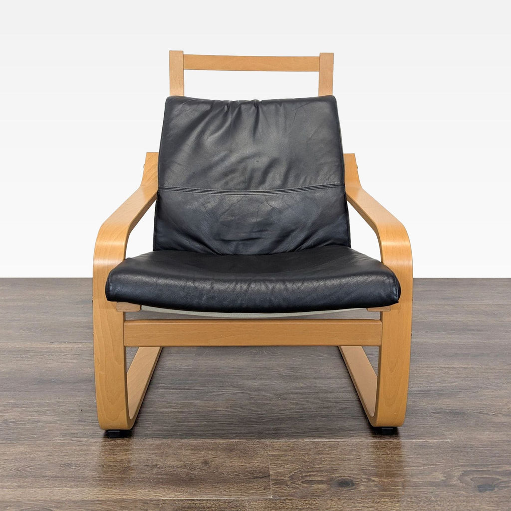 Sleek lounge seating featuring a curved wooden frame and plush black leather cushion for comfort.