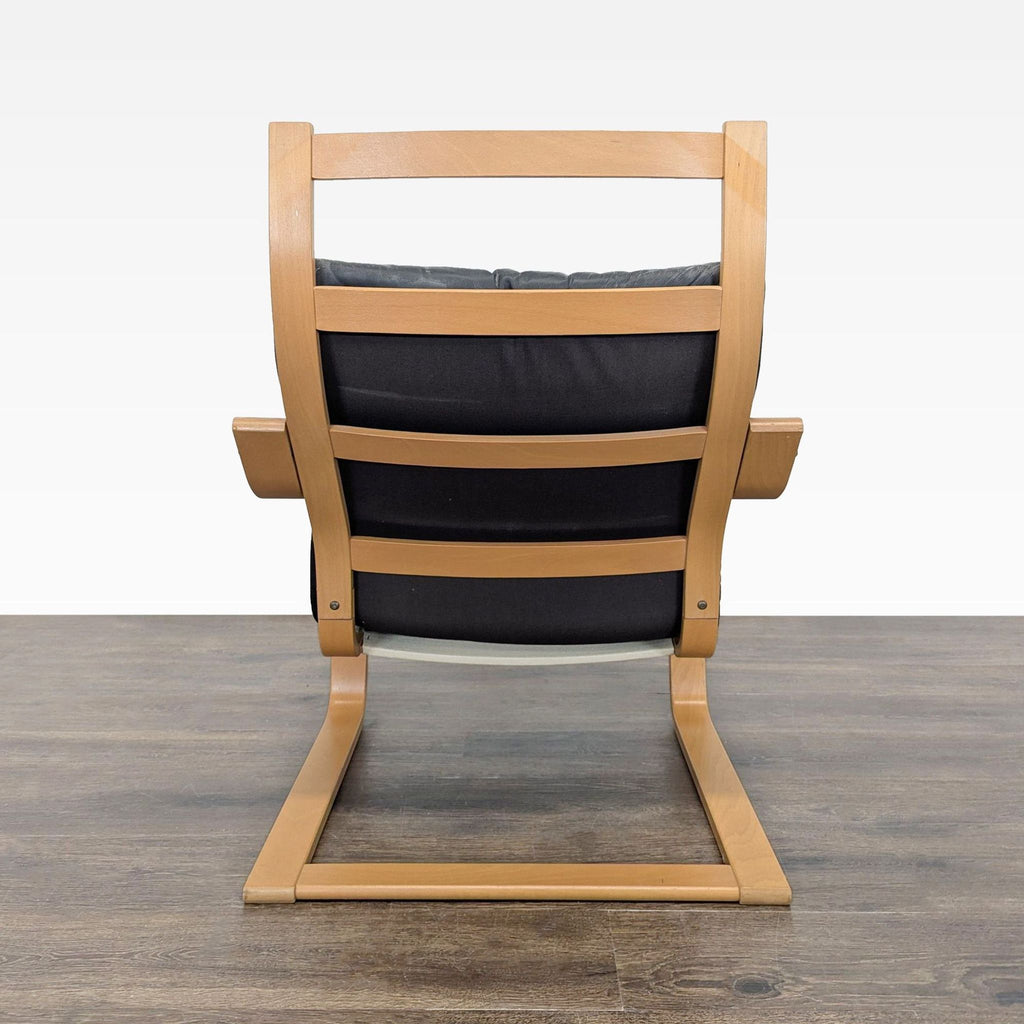 Contemporary bentwood and black leather lounge chair, perfectly suited for relaxing or reading.