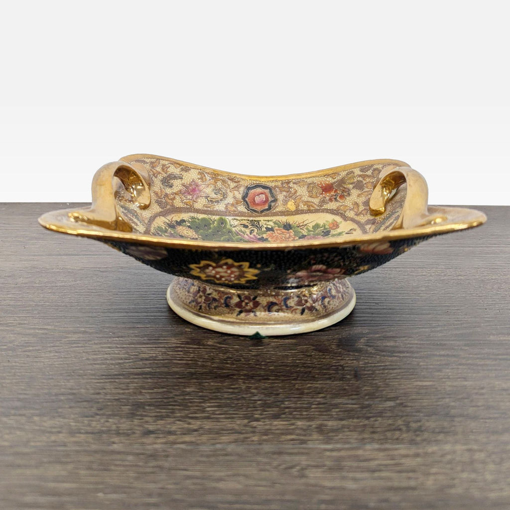 Peacock and floral footed dish with ornate gold handles and intricate textured enamel decoration.  
