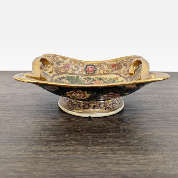 Peacock and floral footed dish with ornate gold handles and intricate textured enamel decoration.  