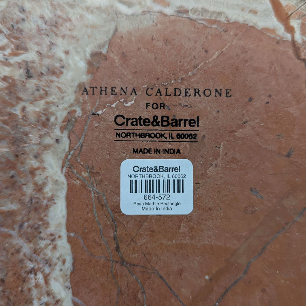 Designer Athena Calderone’s oval-indented Rosa Marble board for Crate & Barrel, polished stone surface.