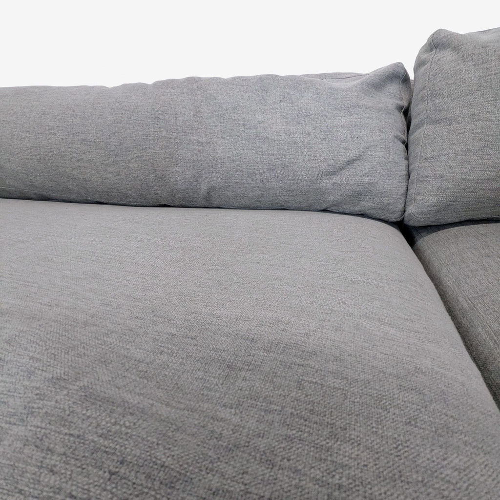 Interior Define sectional couch with clean lines, plush grey upholstery, and ample seating on a walnut frame.