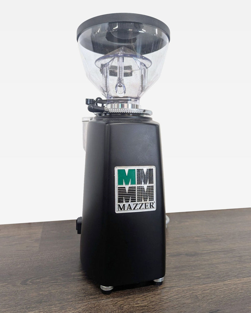Compact Mazzer grinder featuring sturdy construction, visible bean storage, and user-friendly operation.
