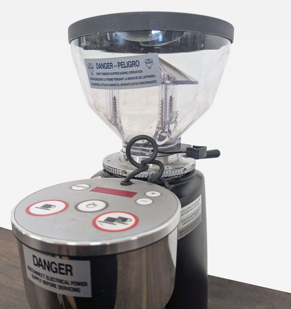 Stainless steel Mazzer coffee maker with transparent hopper, ideal for consistent grinding at home or business.