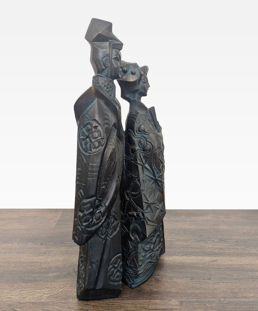 Elegant sculpture of two figures in Japanese attire with intricate detailing and a dark, eye-catching finish.