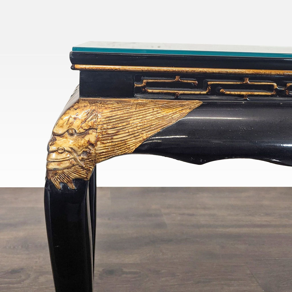 Decorative console table featuring scenic artwork, gold highlights, and a protective glass surface.