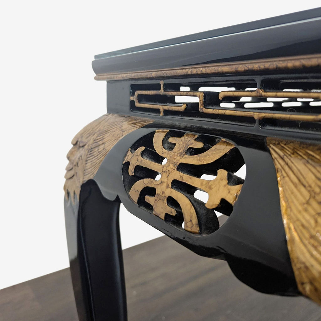 Custom console table with ornate carving, artistic painted details, gold trim, and a glass top.