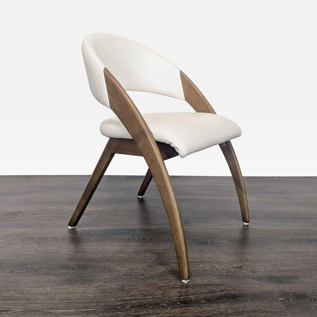 Cream vegan leather dining chair with a sleek walnut ash frame, designed in a mid-century modern style.