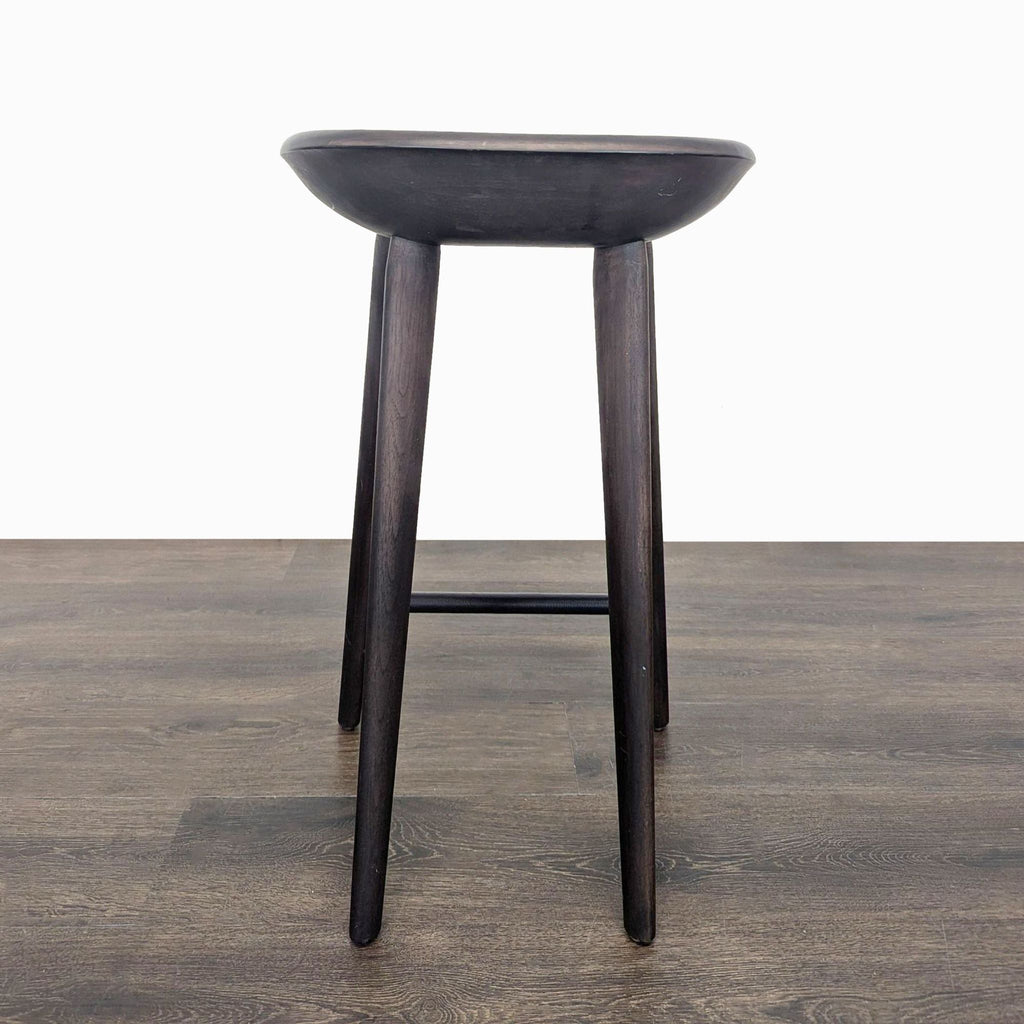 2. Single dark wood stool with curved seat and four sturdy round legs, shown against a white background.  