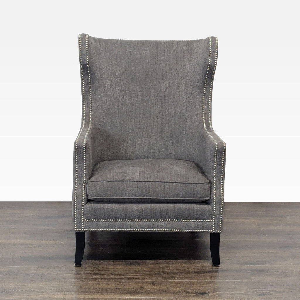 1. Front view of a Bernhardt lounge chair in gray with a high back, winged sides, and nailhead trim.  