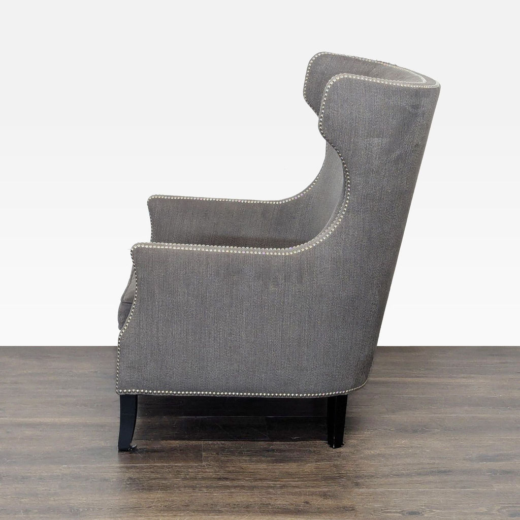3. Side profile of a gray Bernhardt lounge chair, showing winged sides, high back, and decorative nailhead trim.