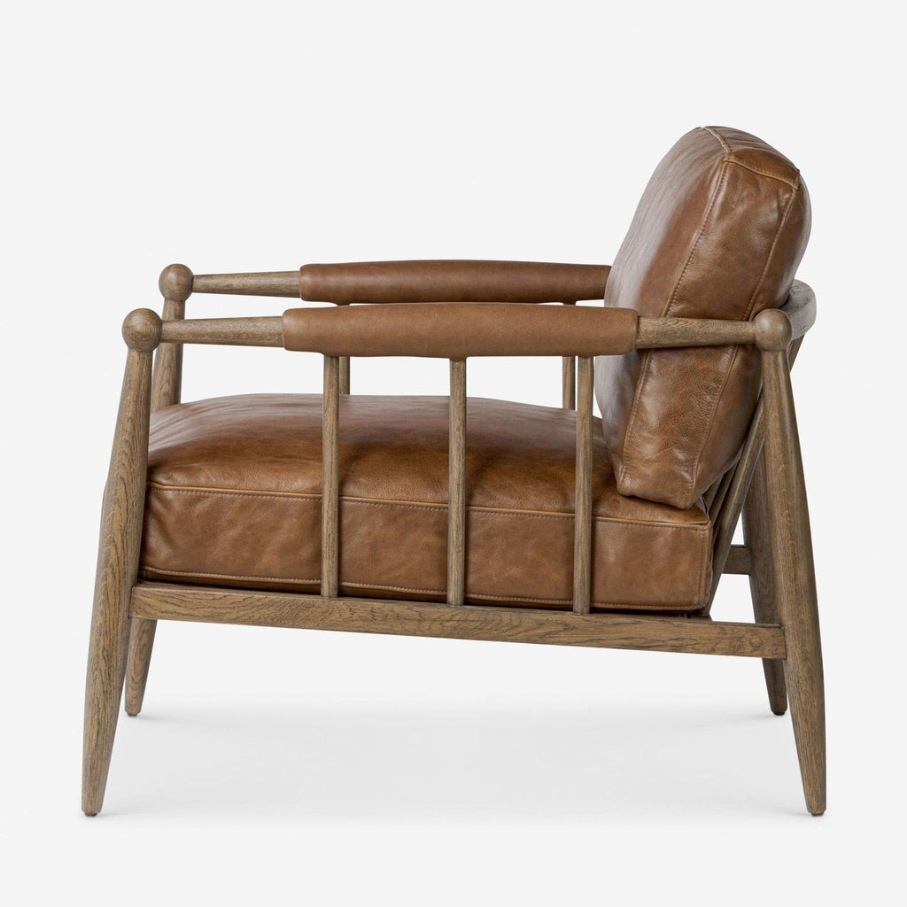 3. Side profile of the Lulu and Georgia lounge chair with a brown leather seat and supportive wooden frame.