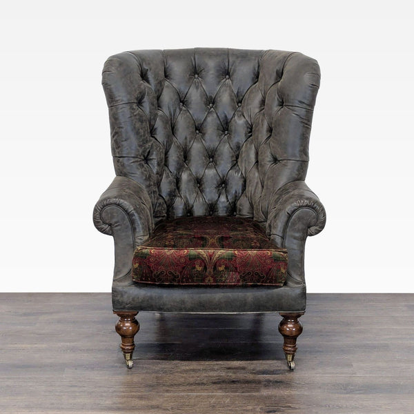 Classic lounge chair by Lillian August with tufted grey leather, patterned cushion, and wooden legs with brass castors.