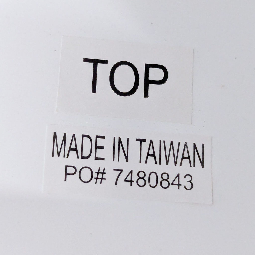 Close-up label on coffee table reading "TOP" and "MADE IN TAIWAN PO# 7480843".  