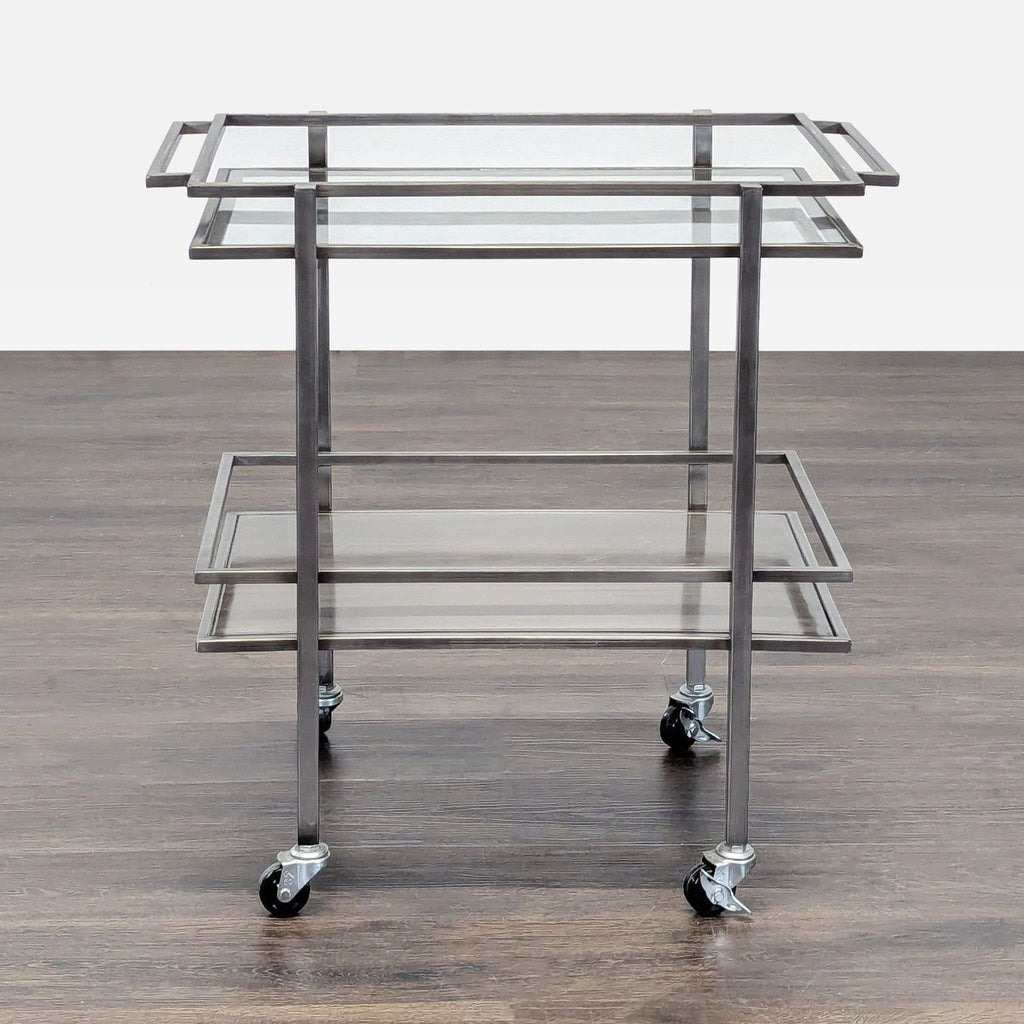 1. A metal and glass rolling cart with two shelves, viewed from the front on a wood floor.
