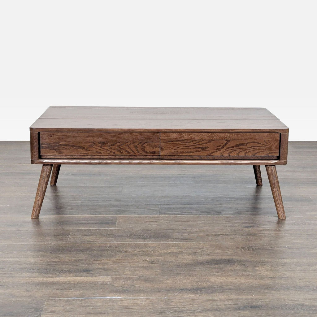 1. Mid-century modern coffee table with two drawers, dark wood finish, and angled legs on a wood floor.