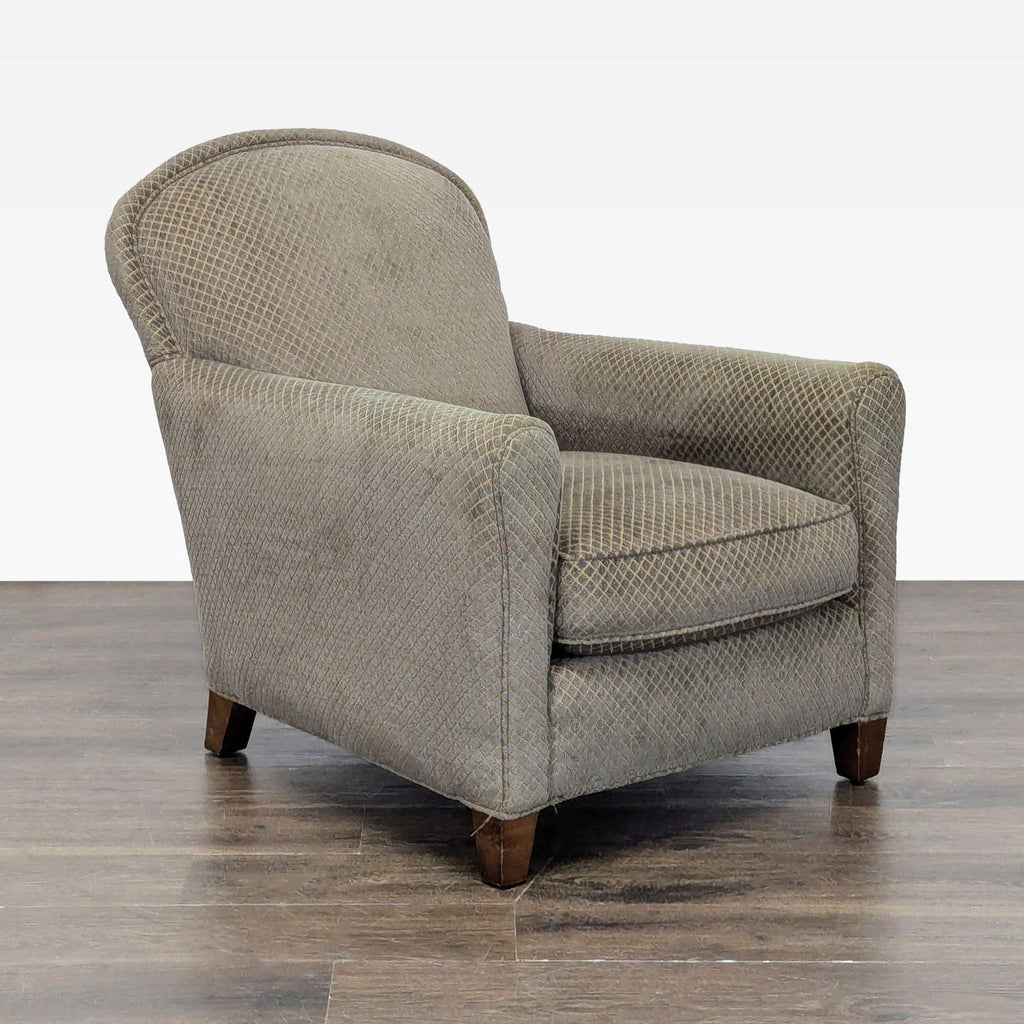 Classic lounge chair by Crate & Barrel, featuring comfortable fabric and a sturdy wood base in neutral tones.