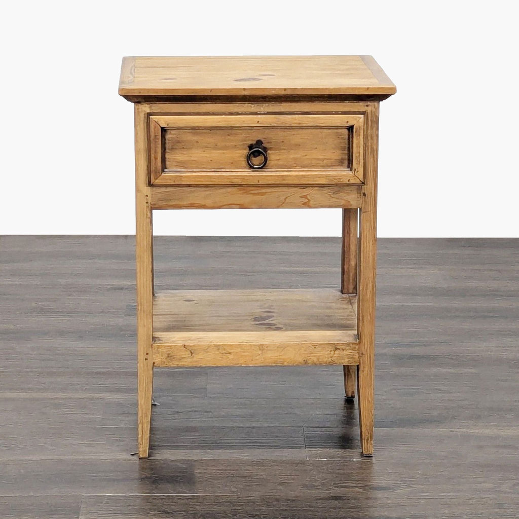 1. Pottery Barn wooden end table with single drawer and shelf, shown from the front on a wooden floor.