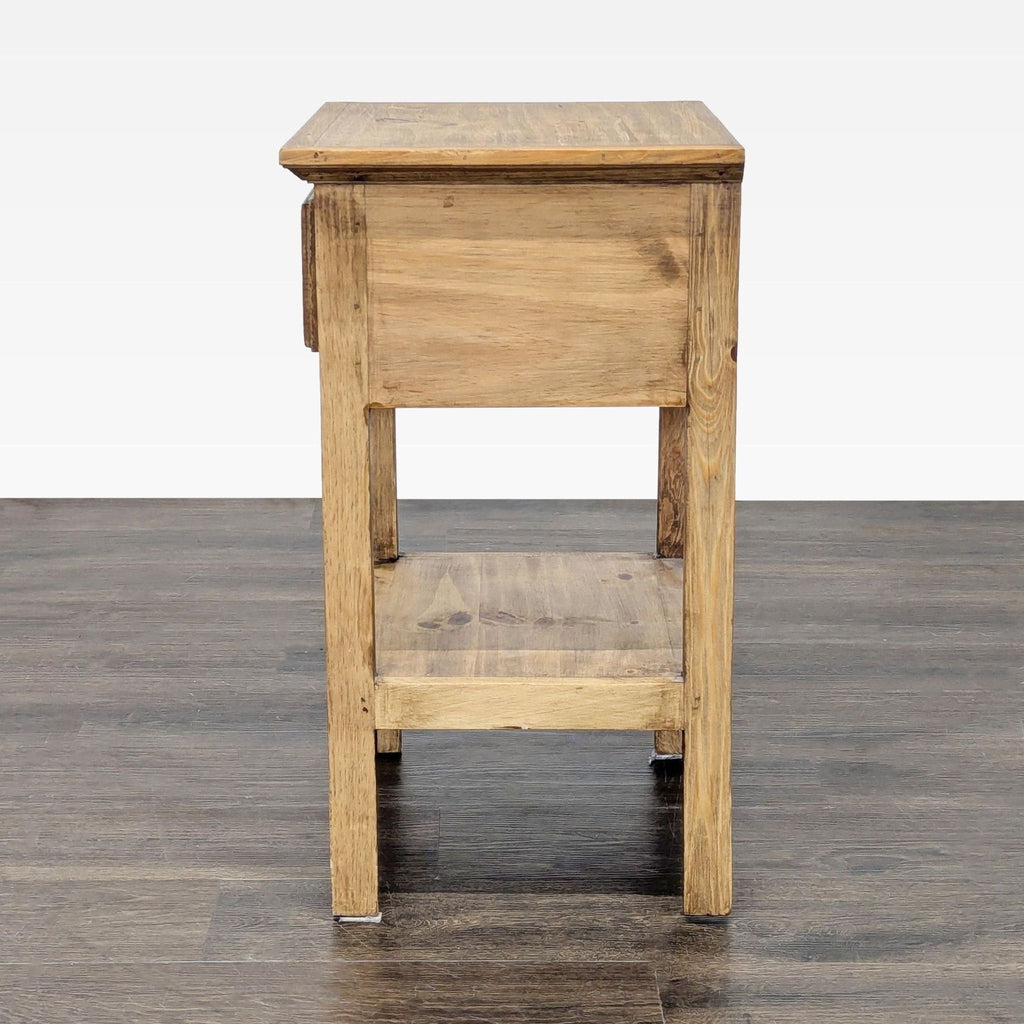 3. Side profile of a Pottery Barn wooden end table with lower shelf and drawer not visible from this angle.
